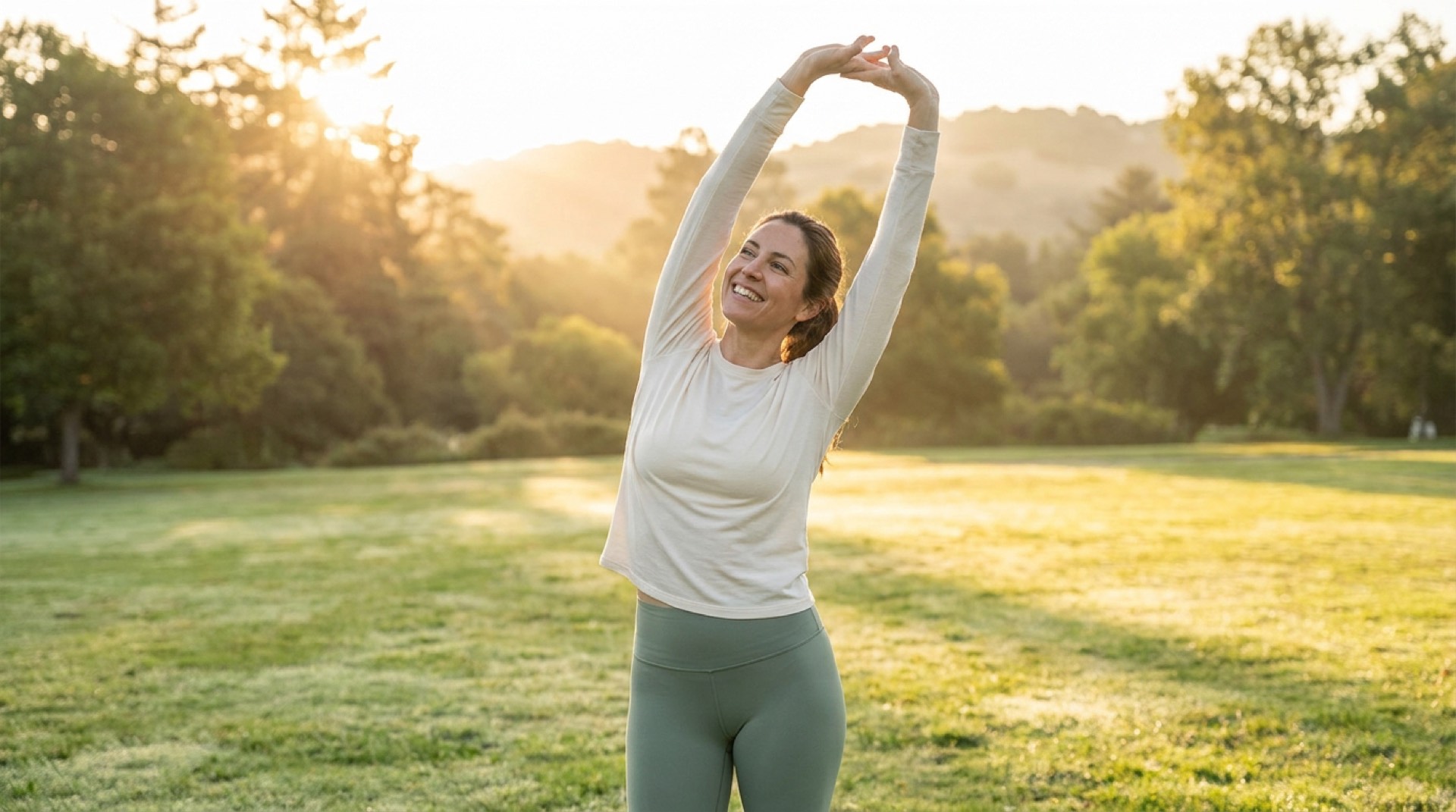 Woman stretching outdoors at sunrise